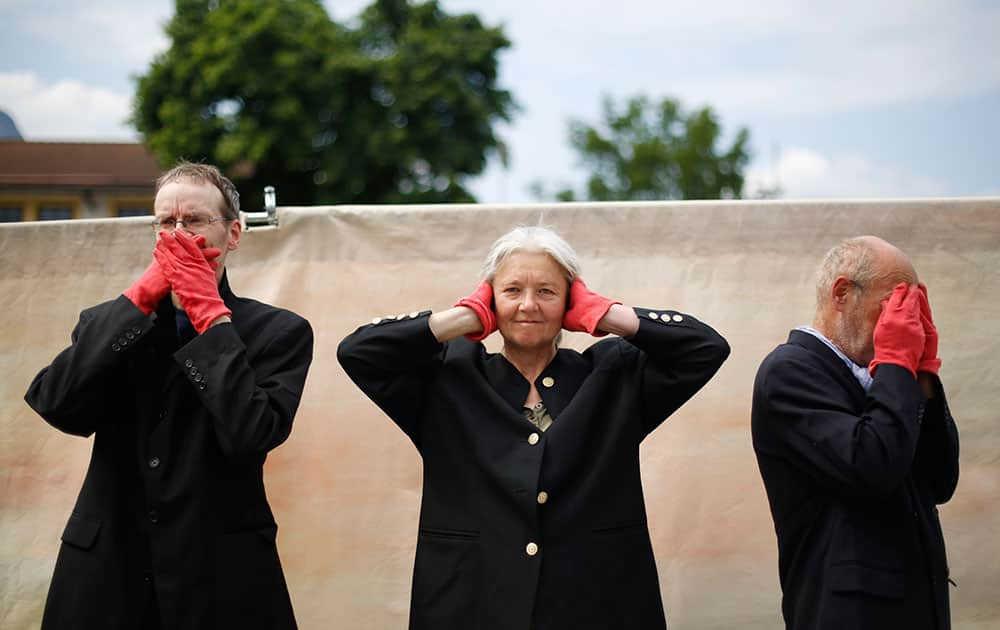 Demonstrators stage the three wise monkeys - not saying, not hearing, not seeing - during a protest in Garmisch-Partenkirchen, southern Germany.