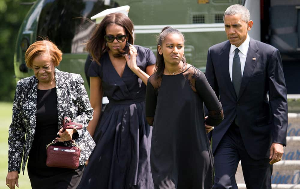 President Barack Obama, and his family, first lady Michelle Obama, daughter Sasha Obama, and mother-in-law Marian Robinson, exit Marine One on the South Lawn of the White House in Washington.