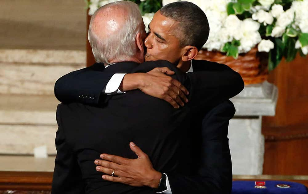 President Barack Obama kisses Vice President Joe Biden during funeral services for Biden's son, Beau Biden, at St. Anthony of Padua Church in Wilmington, Del. 