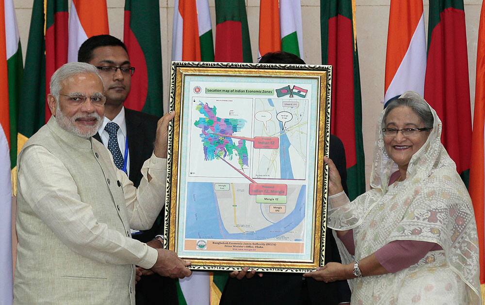 Bangladesh’s Prime Minister Sheikh Hasina, right, and Indian Prime Minister Narendra Modi hold a location map of Indian Economic Zones during an agreement program in Dhaka, Bangladesh.