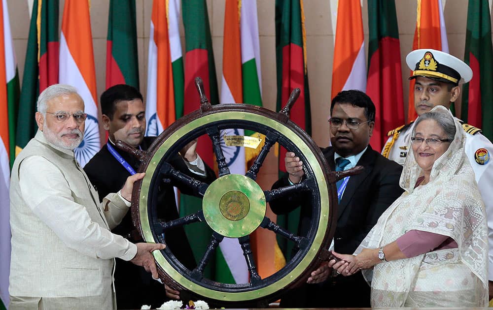 Indian Prime Minister Narendra Modi hands over the steering wheel of the INS Vikrant, Indian Navy's aircraft carrier, to Bangladesh’s Prime Minister Sheikh Hasina, in Dhaka, Bangladesh.