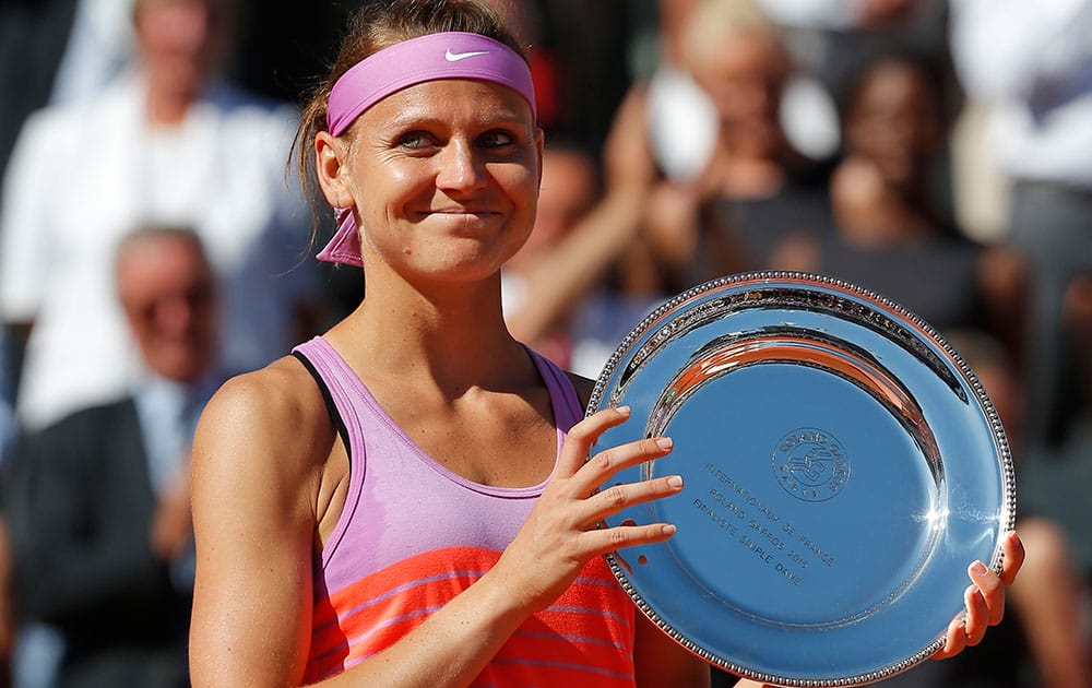 Lucie Safarova of the Czech Republic holds the runner-up trophy after losing the final of the French Open tennis tournament against Serena Williams of the U.S. in three sets, 6-3, 6-7, 6-2, at the Roland Garros stadium.