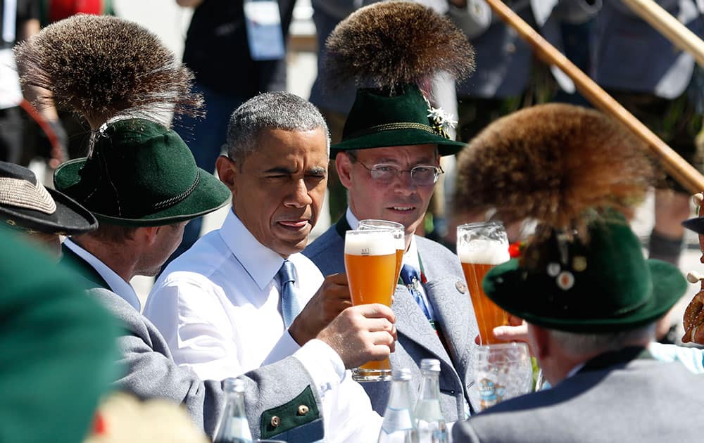 U.S. President Barack Obama toasts with traditionally dressed Bavarian during a visit the village of Kruen, southern Germany.