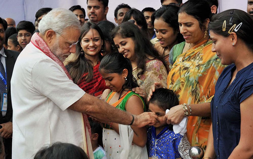Prime Minister Narendra Modi plays with a kid during a visit to New Chancery Complex in Dhaka.