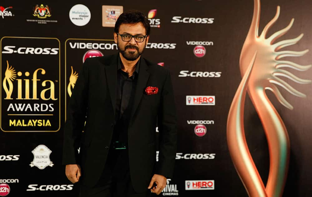 Telugu star Venkatesh poses on the green carpet as he arrives at the International Indian Film Academy (IIFA) awards in Kuala Lumpur, Malaysia.