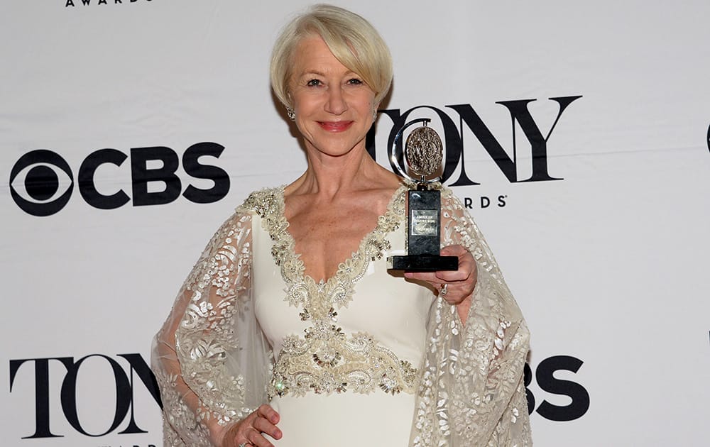 Helen Mirren poses in the press room with the award for best performance by an actress in a leading role in a play for 'The Audience' at the 69th annual Tony Awards, in New York.