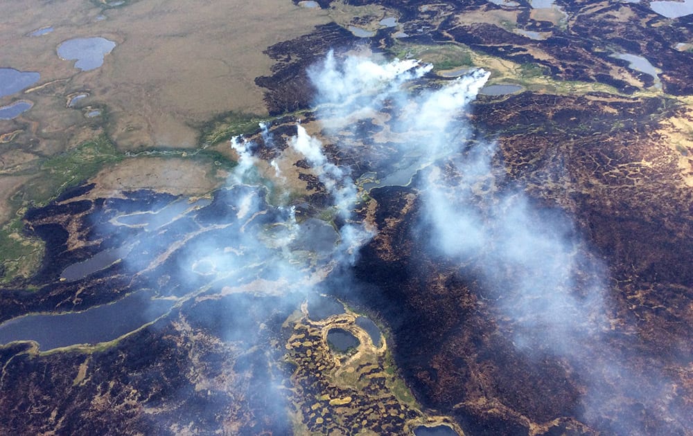 smoke rises from the Bogus Creek Fire, one of two fires burning in the Yukon Delta National Wildlife Refuge in southwest Alaska. 