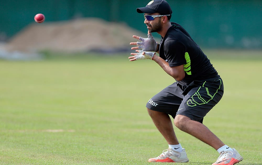 Ajinkya Rahane prepares to take a catch during a practice session ahead of their test cricket match against Bangladesh in Dhaka, Bangladesh.