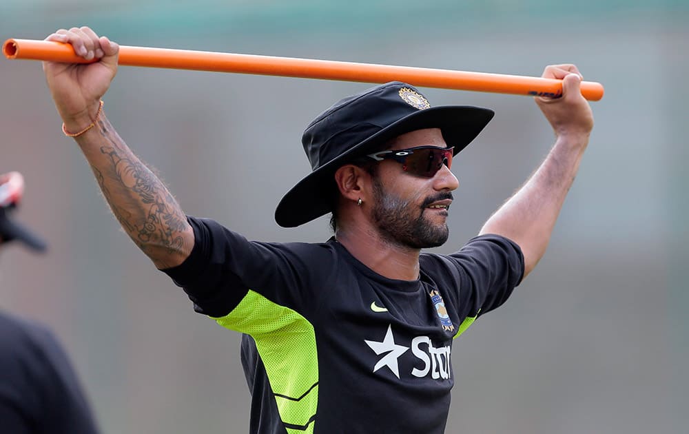 Shikhar Dhawan stretches during a practice session ahead of their test cricket match against Bangladesh in Dhaka, Bangladesh.