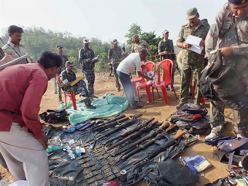 CRPF personnel recover arms and ammunitions after an encounter with Maoist rebels.