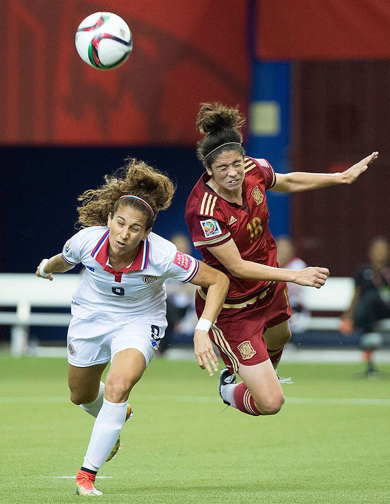 Costa Rica's Carolina Venegas, left, and Spain's Marta Torrejon (18) battle for a head ball during the first half of a FIFA Women's World Cup soccer match in Montreal, Canada.