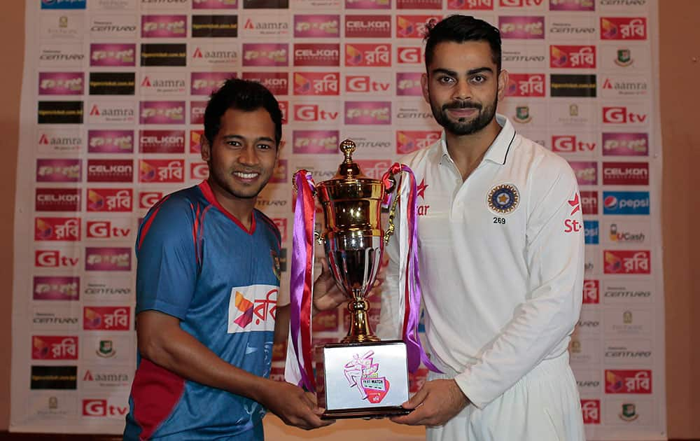 INDIA’S TEST MATCH CAPTAIN VIRAT KOHLI, RIGHT, AND BANGLADESH’S TEST MATCH CAPTAIN MUSHFIQUR RAHIM POSE WITH THE TROPHY ON THE EVE OF THE ONLY TEST MATCH OF THEIR SERIES IN DHAKA, BANGLADESH.