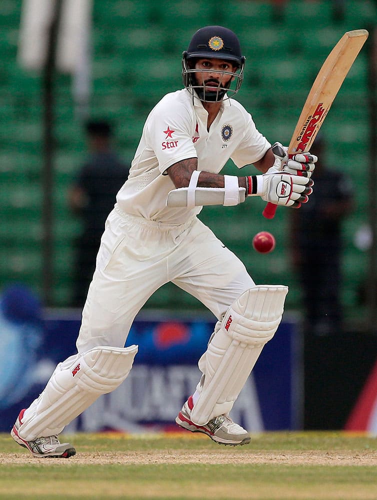 India’s Shikhar Dhawan plays a shot during the first day of their test cricket match against Bangladesh in Fatullah, Bangladesh.