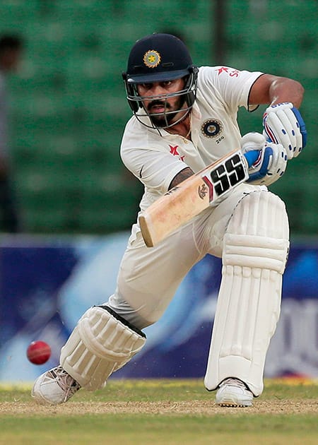 Murali Vijay plays a shot during the first day of their test cricket match against Bangladesh in Fatullah, Bangladesh.