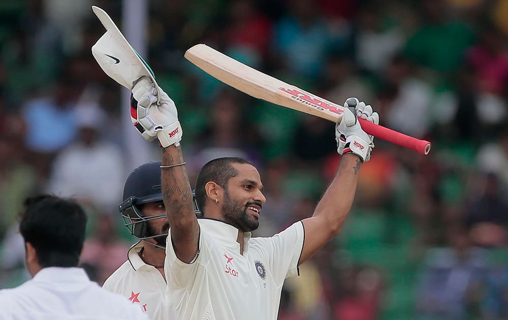 Shikhar Dhawan, acknowledges the crowd after scoring a hundred runs during the first day of their test cricket match against Bangladesh in Fatullah, Bangladesh.