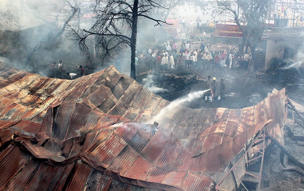 Firemen extinguishing a major blaze that broke out in saw mill and Dal mill in Kalamna area in Nagpur, Maharashtra.