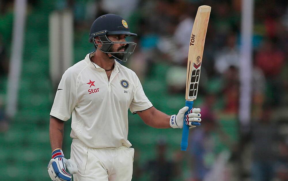 Murali Vijay acknowledges the crowd after scoring fifty runs during the first day of their test cricket match against Bangladesh in Fatullah, Bangladesh.