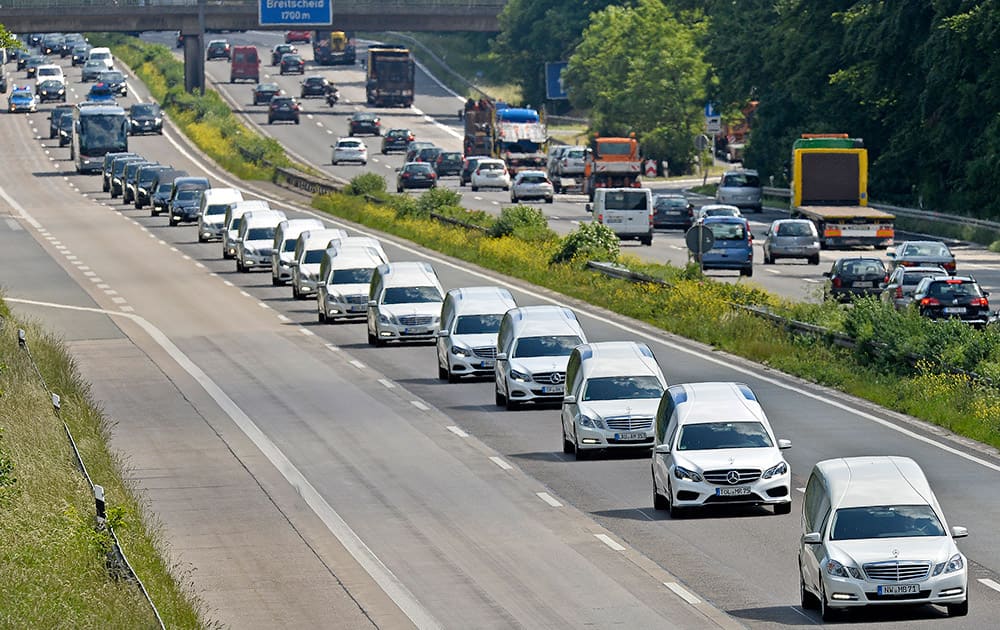 A convoy of hearses drives on the highway in Duisburg, Germany, taking home 16 school children who died in the Germanwings plane crash in March. The coffins, that arrived at the airport in Duesseldorf Tuesday evening, are brought to their families in the city of Haltern.
