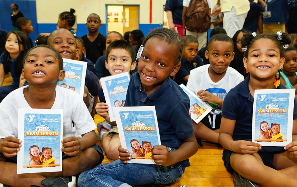 Students from Edward M. Stanton Elementary School in South Philadelphia hold certificates for free water safety lessons from their local Christian Street YMCA in Philadelphia.