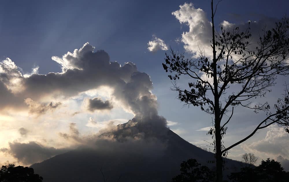 Mount Sinabung spews volcanic smoke from its crater as seen from Tiga Pancur, North Sumatra, Indonesia.