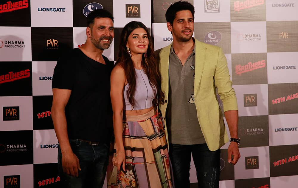 Bollywood actress, Jacqueline Fernandez poses with co actors Akshay Kumar left, and Sidharth Malhotra, right during the trailer launch of her upcoming film ‘Brothers’ in Mumbai, India.