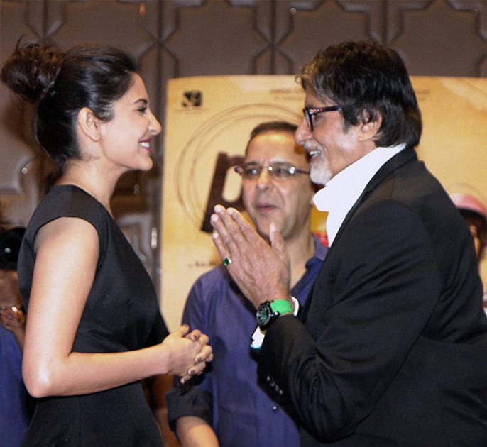 Bollywood actors Amitabh Bachchan and Anushka Sharma with filmmaker Vidhu Vinod Chopra during the success party of film PK in Mumbai.