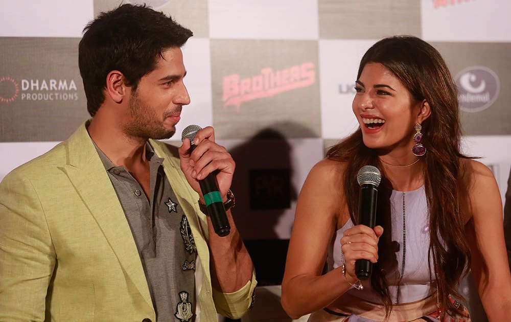 Bollywood actress, Jacqueline Fernandez right, shares a lighter moment with co star Sidharth Malhotra during the trailer launch of their upcoming film ‘Brothers’ in Mumbai.