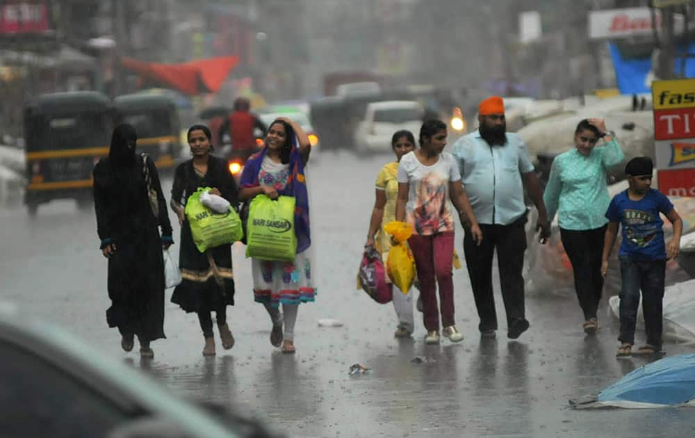 People enjoy walk on the street during monsoon rains in Nagpur Maharashtra.