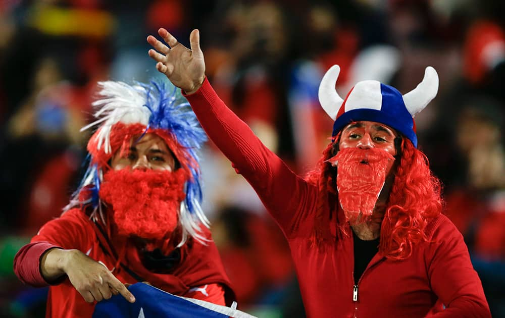 Chilean fans cheer during the opening ceremony of the Copa America soccer tournament at the National Stadium in Santiago, Chile.