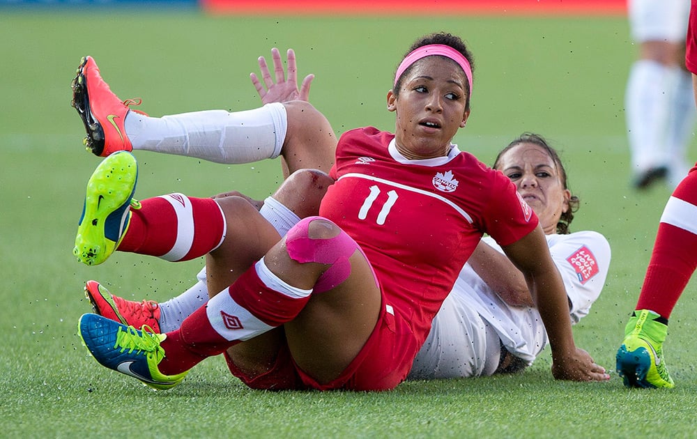 Canada's Desiree Scott (11) and New Zealand's Amber Hearn become entangled during first-half FIFA Women's World Cup soccer game action in Edmonton, Alberta.