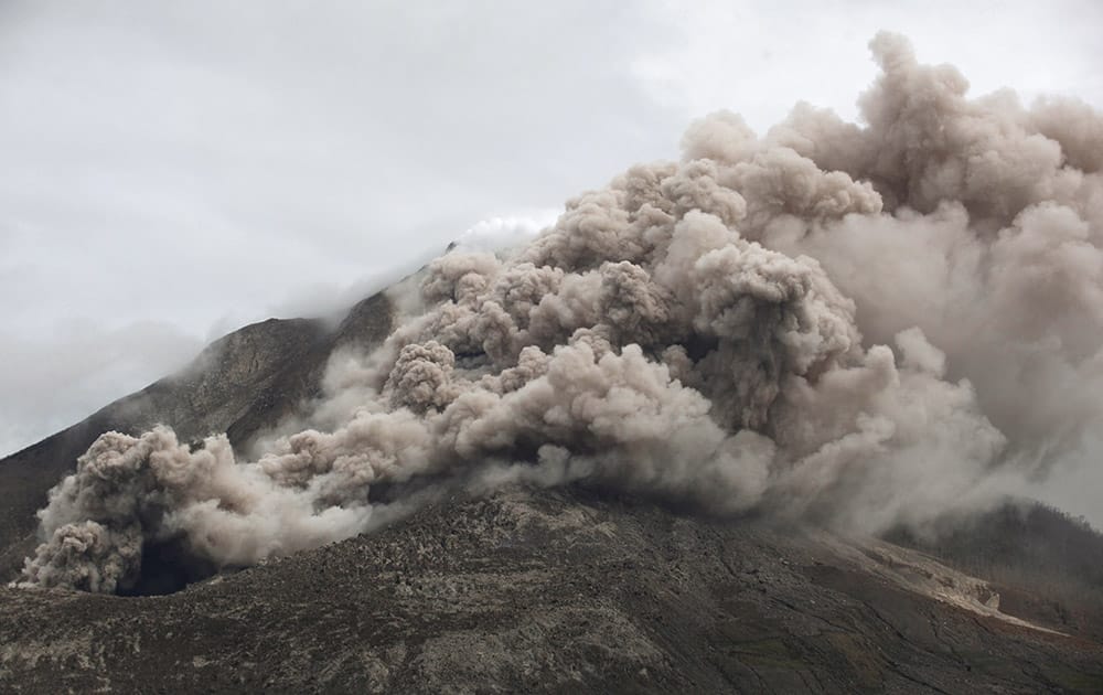 Mount Sinabung releases pyroclastic flows as seen from Tiga Serangkai, North Sumatra, Indonesia. The volcano has sporadically erupted since 2010 after being dormant for 400 years. 