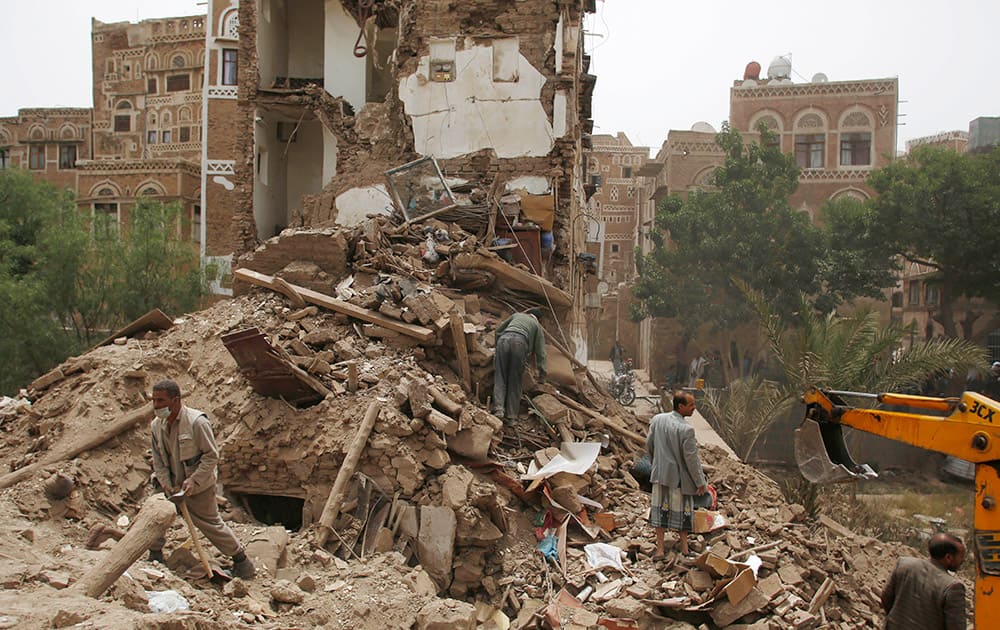 People search for survivors under the rubble of houses destroyed by Saudi airstrikes in the old city of Sanaa, Yemen.