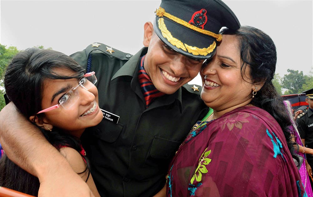 A cadet is greeted by his family after the passing out parade at Officers Training Academy in Gaya.