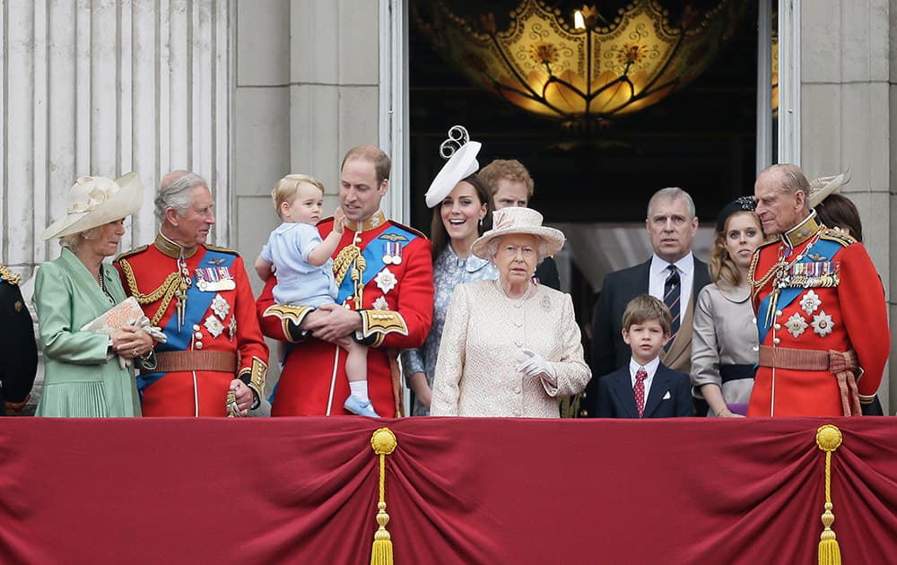 Britain's Prince William holds his son Prince George, with Queen Elizabeth II, front centre, The Duchess of Cornwall, The Prince of Wales, Kate, Duchess of Cambridge and Prince Philip, right, during the Trooping The Colour parade at Buckingham Palace, in London.