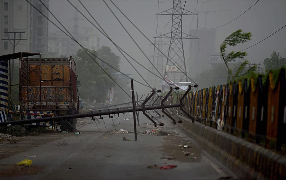 An electric line gets damaged collapse of many poles in a strong dust storm at Vasundhra in Gahziabad.