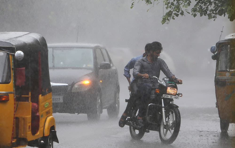 A motorist rides during a rain in Hyderabad, India.