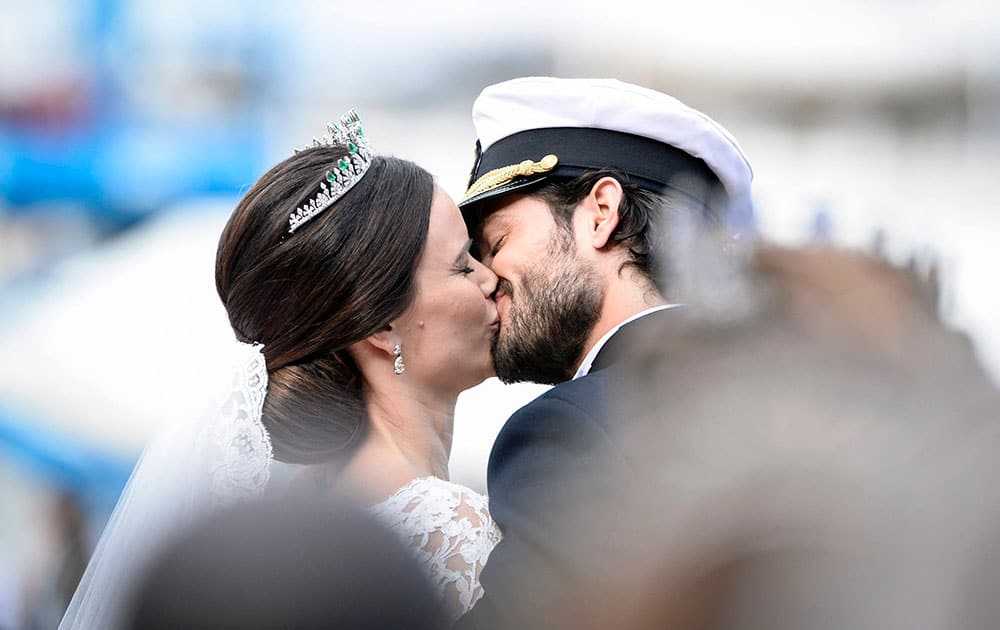 Sweden's Prince Carl Philip kisses his bride, Sofia Hellqvist in a carriage, after their wedding ceremony, in Stockholm, Sweden.