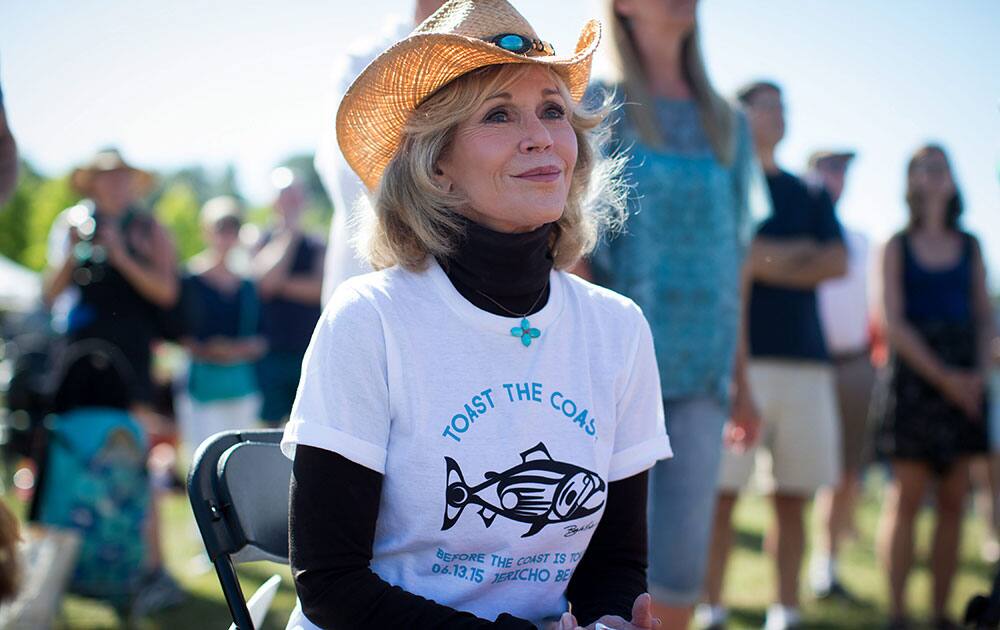 Actress Jane Fonda listens to speakers during the 