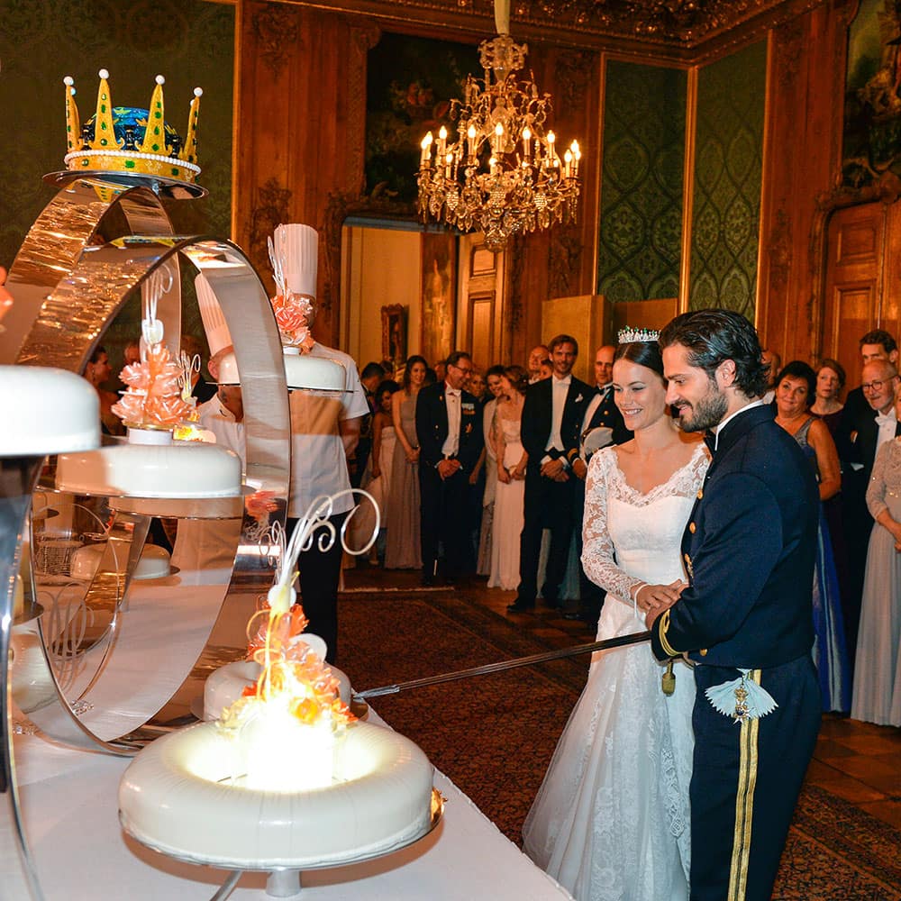 Sweden's Prince Carl Philip, right, and Sofia Hellqvist, second left, cut the wedding cake during their wedding in the royal place in Stockholm.