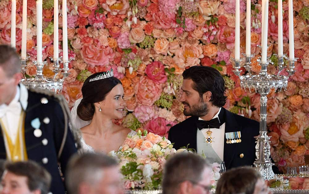 Sweden's Prince Carl Philip, right, looks at Princess Sofia, during the wedding dinner at the Royal Palace, in Stockholm, after their wedding ceremony.