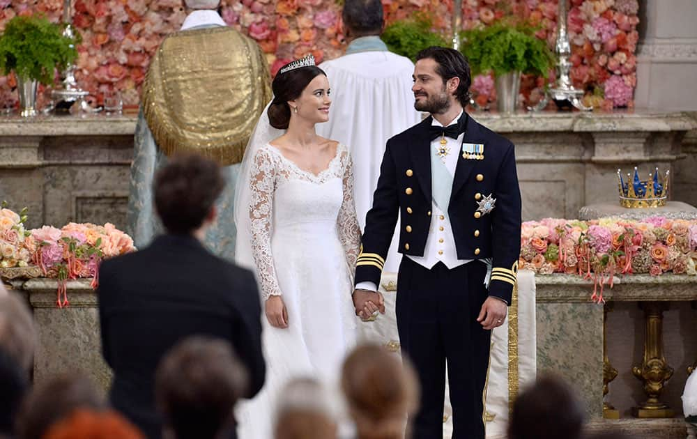 Sweden's Prince Carl Philip and Sofia Hellqvist stand at the altar during their wedding the Royal Chapel in Stockholm, Sweden.