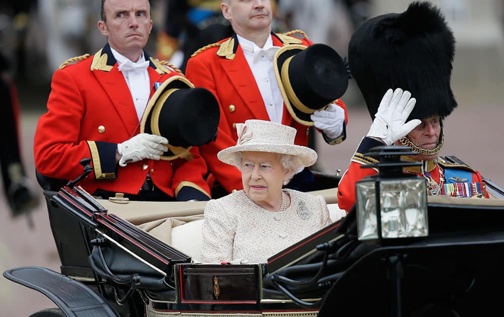 Britain's Queen Elizabeth II and Prince Philip ride in a carriage during the Trooping The Colour parade at Buckingham Palace, in London.