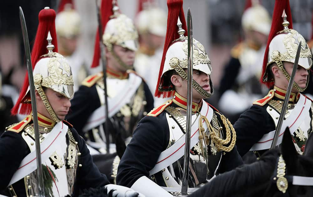 Soldiers of the Household Cavalry wait for the arrival of the carriages during the Trooping The Colour parade at Buckingham Palace, in London.