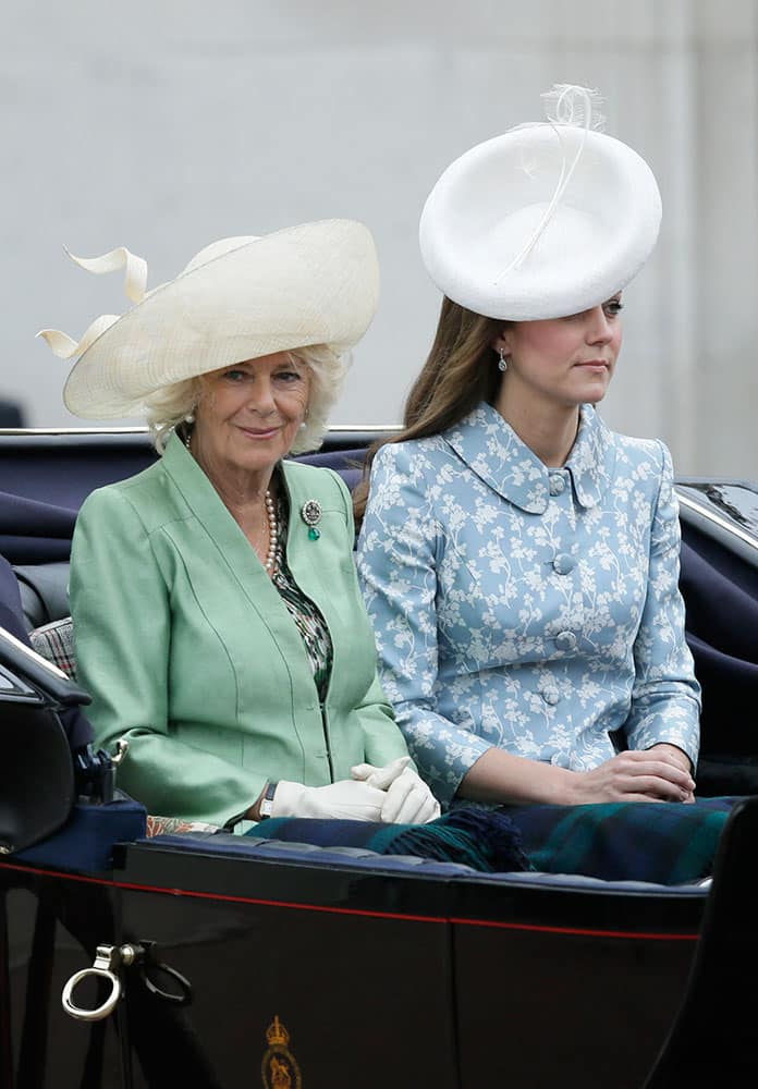 Britain's Kate, Duchess of Cambridge, right, and the Duchess of Cornwall ride in a carriage during the Trooping The Colour parade at Buckingham Palace, in London.