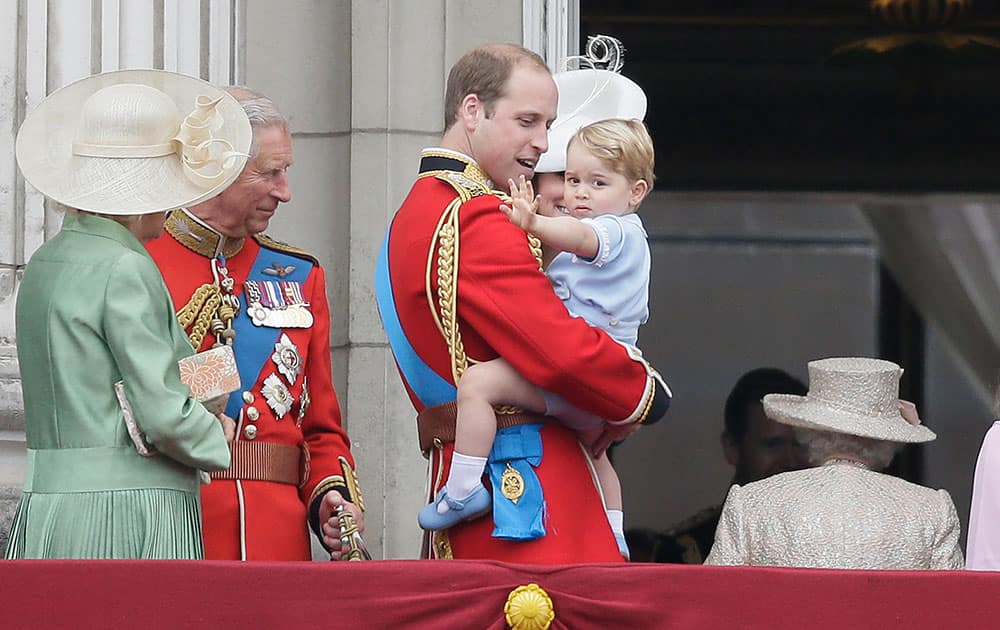 Britain's Prince William holds his son Prince George as they leave the balcony following the Trooping The Colour parade at Buckingham Palace, in London.