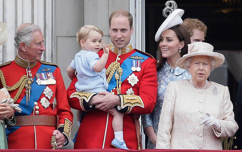 Britain's Prince William holds his son Prince George, with Queen Elizabeth II, right, Kate, Duchess of Cambridge and the Prince of Wales during the Trooping The Colour parade at Buckingham Palace, in London.