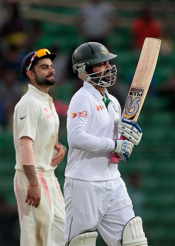 India’s captain Virat Kohli, left, and Bangladesh’s Tamim Iqbal walk back to the pavilion at the end of their cricket test match in Fatullah, Bangladesh.