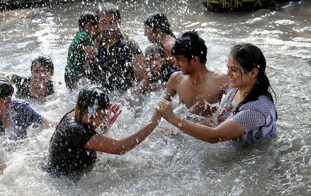 People enjoy a dip in Ranbir Canal to beat the heat in Jammu.