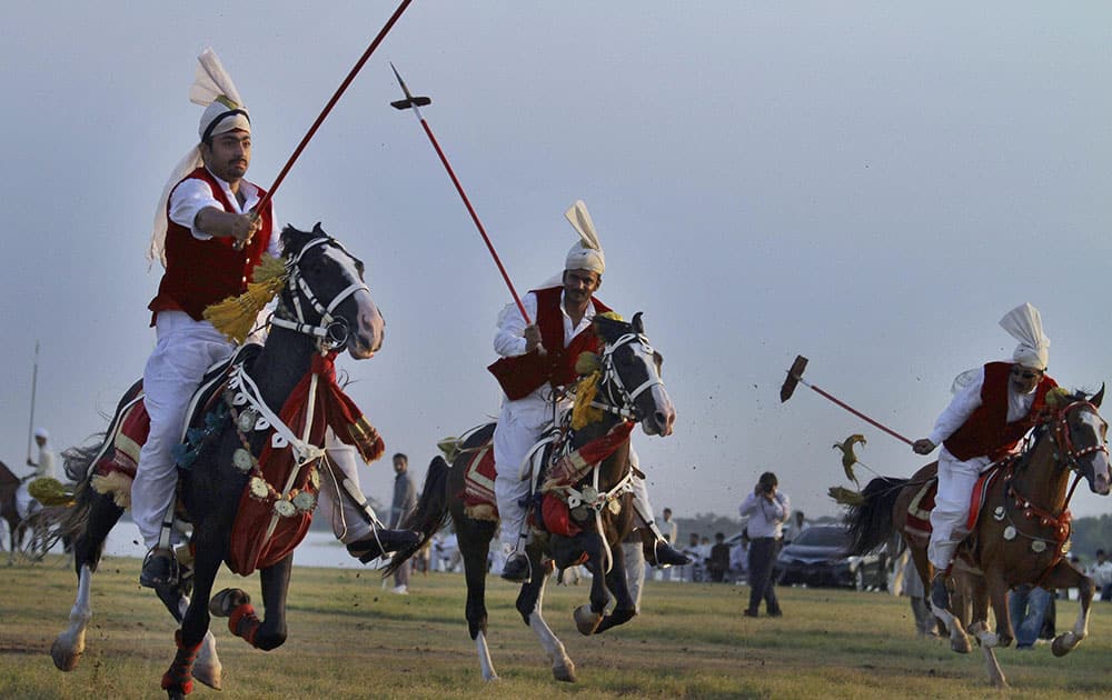 Pakistani horse riders target wooden pegs during a tent pegging competition arranged by the Pakistan Tent Pegging Association in Islamabad, Pakistan.