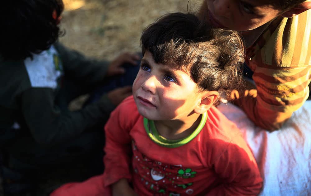 Syrian refugee children are stuck after breaking the border fence and crossing into Turkey from Syria, in Akcakale, Sanliurfa province, southeastern Turkey.